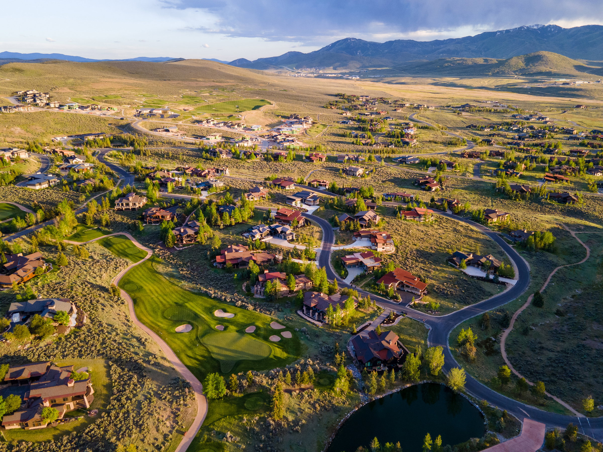 Expansive aerial view showcasing a residential community nestled among rolling hills