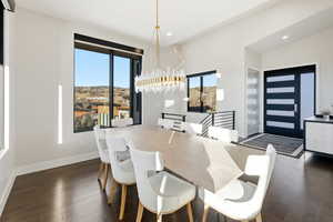 Dining room with dark wood-style floors, a chandelier, recessed lighting, and lofted ceiling