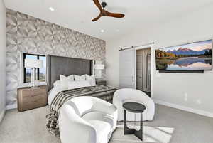 Carpeted bedroom featuring a barn door, an accent wall, ceiling fan, wallpapered walls, and recessed lighting