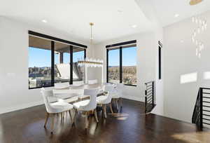 Dining space featuring dark wood-style flooring, recessed lighting, and a chandelier