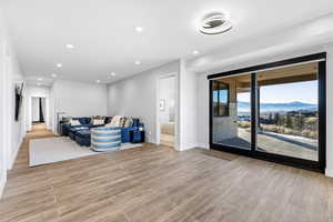 Living area with a mountain view, recessed lighting, and wood tiled floors