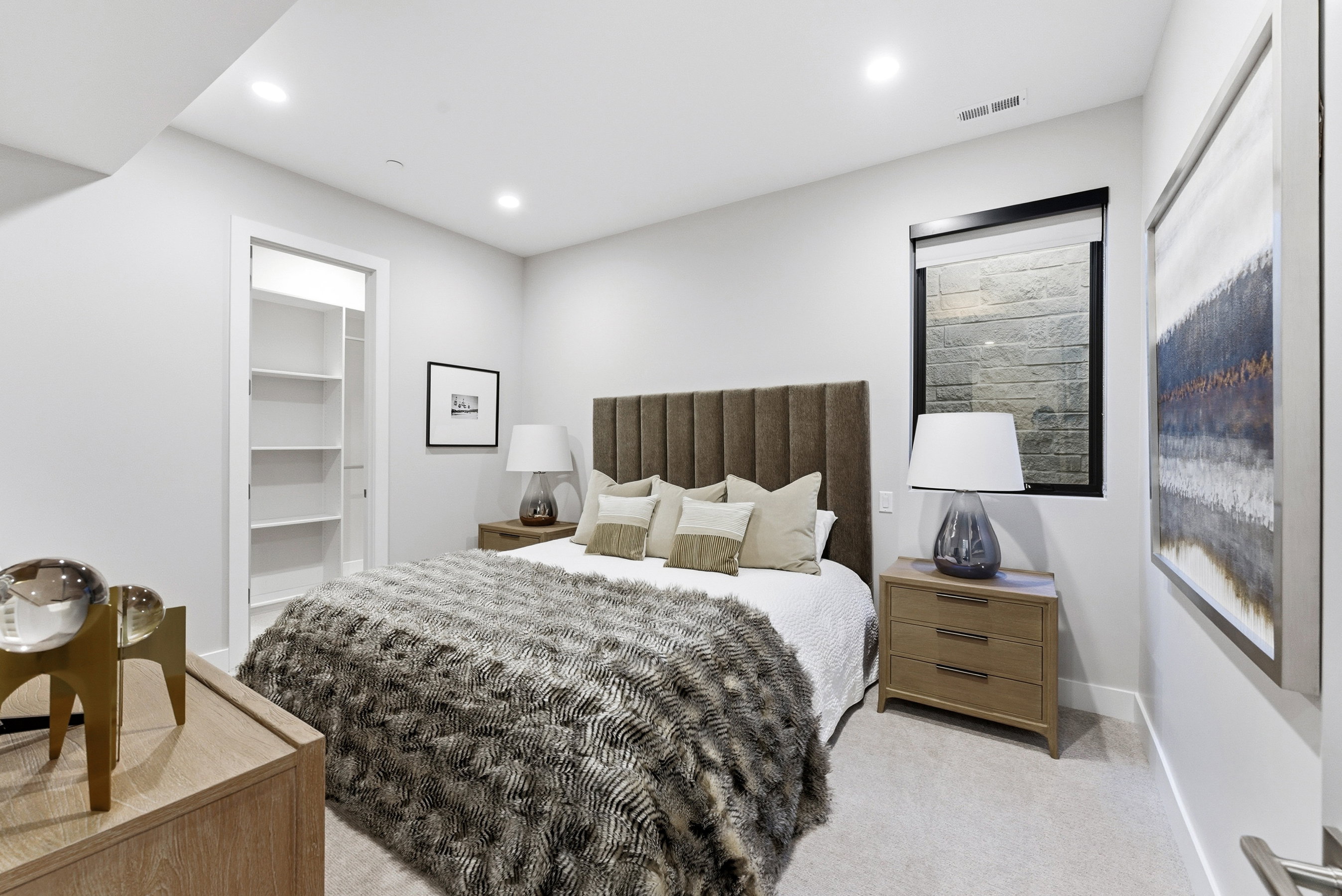 Bedroom featuring recessed lighting, a built-in closet with shelving, and light-toned carpet flooring