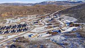 Snowy aerial view with a mountain view and a residential view
