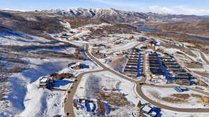 Snowy aerial view with a water and mountain view