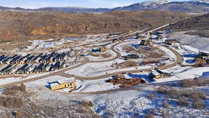 Snowy aerial view with a residential view and a mountain view