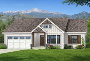 View of front of home with roof with shingles, a mountain view, a front lawn, concrete driveway, and a garage