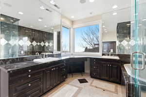 Full bathroom with vanity, a shower stall, and light tile patterned flooring