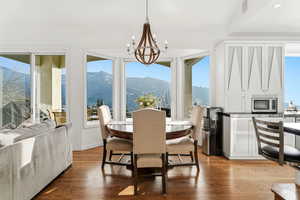 Dining space with a mountain view, plenty of natural light, and a chandelier