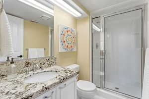 Bathroom featuring vanity and a shower stall
