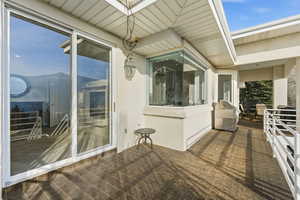 Wooden terrace featuring grilling area and a patio
