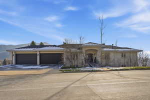 Single story home featuring concrete driveway, stucco siding, and a garage