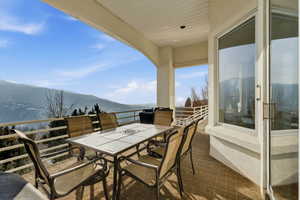 Balcony with a mountain view and outdoor dining area