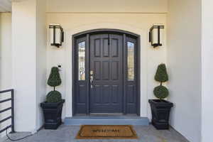 Entrance to property with stucco siding