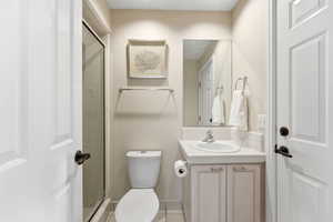 Full bathroom featuring a shower stall and vanity