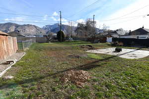 Fenced backyard featuring a patio, an outdoor fire pit, and a mountain view