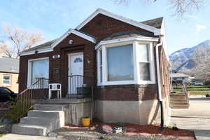 Bungalow featuring brick siding and a mountain view