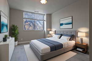 Bedroom featuring wood finished floors and baseboards