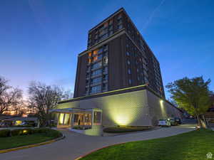 Property at dusk featuring a view of apartment building / complex