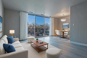 Living area featuring floor to ceiling windows and wood finished floors