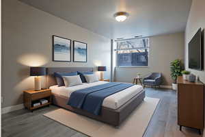 Bedroom with wood finished floors and baseboards