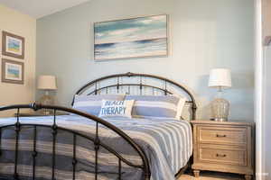 Primary bedroom with vaulted ceiling and private bath.