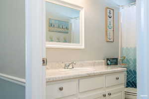 Bathroom with large vanity and a shower with shower curtain
