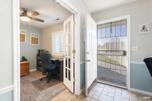 Home office/Flex room featuring French doors and ceiling fan could easily be a guest room.
