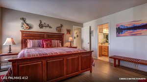 Bedroom featuring dark wood-style flooring and connected bathroom