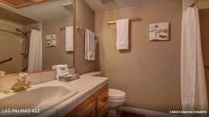 Full bath featuring vanity, tiled shower, and a textured ceiling