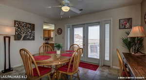 Dining room featuring a ceiling fan, tile patterned floors, and french doors