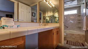 Full bathroom featuring vanity, bathtub / shower combination, and tile patterned flooring