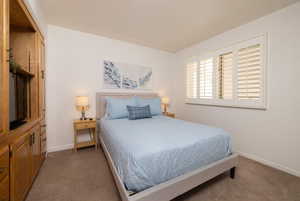 Carpeted bedroom with baseboards