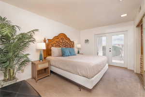 Bedroom featuring access to exterior, carpet floors, and french doors