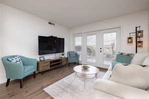 Living area featuring french doors and wood finished floors