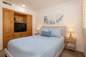 Carpeted bedroom featuring baseboards