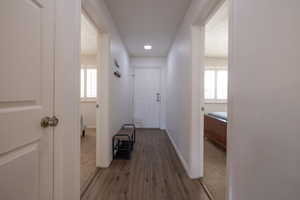 Hallway featuring dark wood finished floors and plenty of natural light