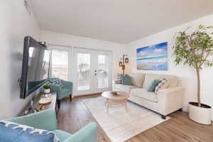 Living room featuring wood finished floors and french doors