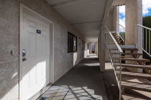 View of exterior entry featuring stucco siding