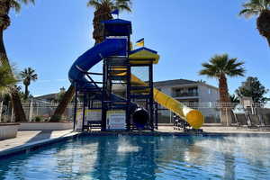 Community pool featuring a water slide