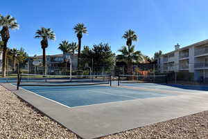 View of tennis court with community basketball court