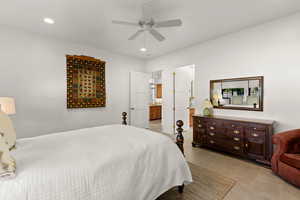 Bedroom with a ceiling fan, recessed lighting, connected bathroom, and light tile patterned floors