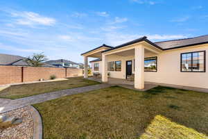 Back of property featuring stucco siding, a patio, and a tile roof