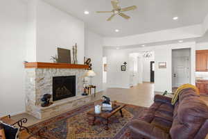 Living area with recessed lighting, a fireplace, light tile patterned floors, a chandelier, and ceiling fan