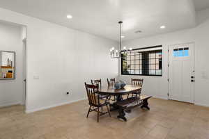 Dining room with a chandelier and recessed lighting