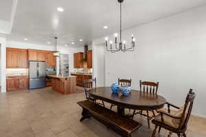 Dining space featuring a chandelier, recessed lighting, and light tile patterned floors