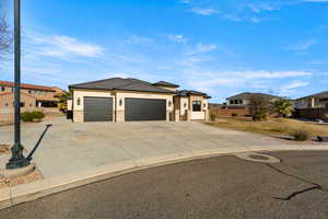 Prairie-style home with a residential view, concrete driveway, a garage, stone siding, and stucco siding