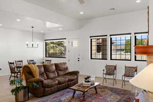 Living room with recessed lighting, light tile patterned flooring, a chandelier, and ceiling fan