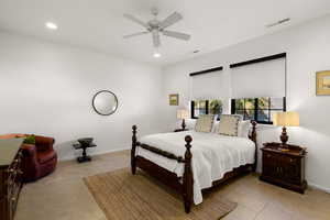 Bedroom with a ceiling fan and recessed lighting