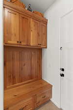 Mudroom with light tile patterned floors