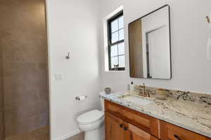 Full bathroom with vanity and toilet